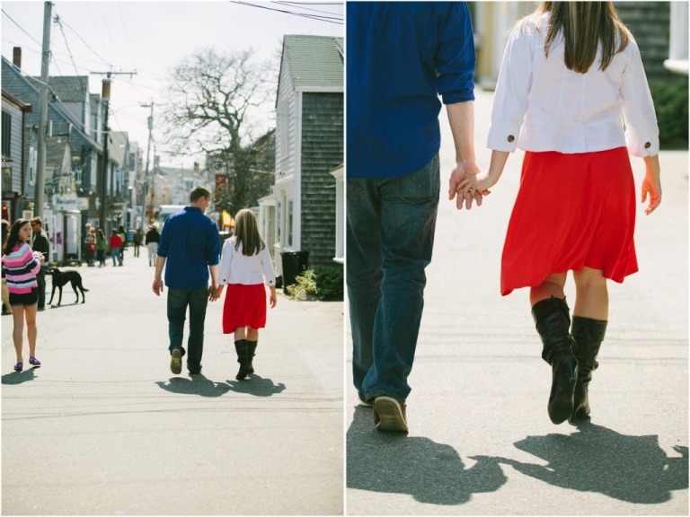 Engaged couple holding hands walking through Bearskin Neck Rockport MA