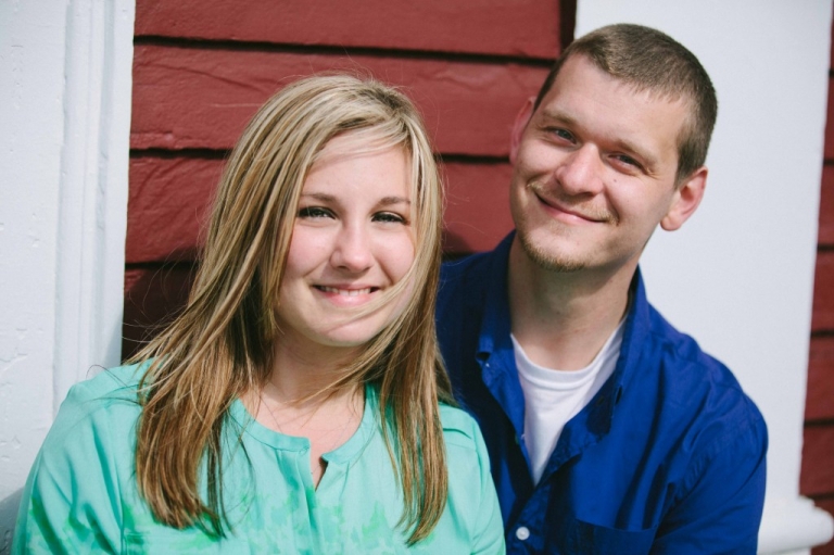 Engaged couple smile during photo session in Rockport
