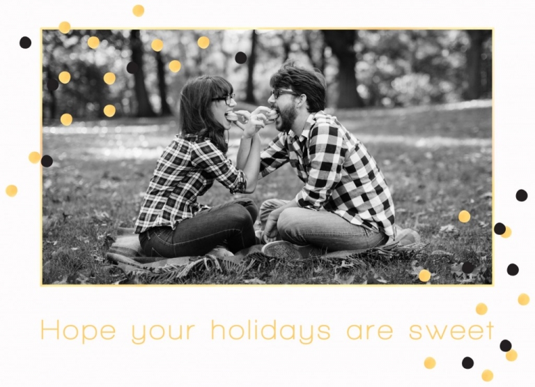 Engaged couple feeding each other macaroons in picture of holiday cards
