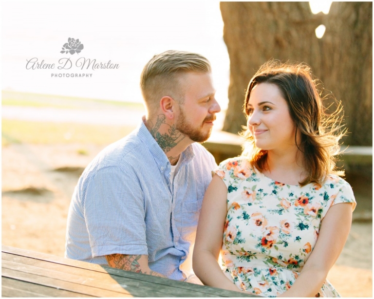 Couple looking into each others eyes during engagement session at Salem Willows 