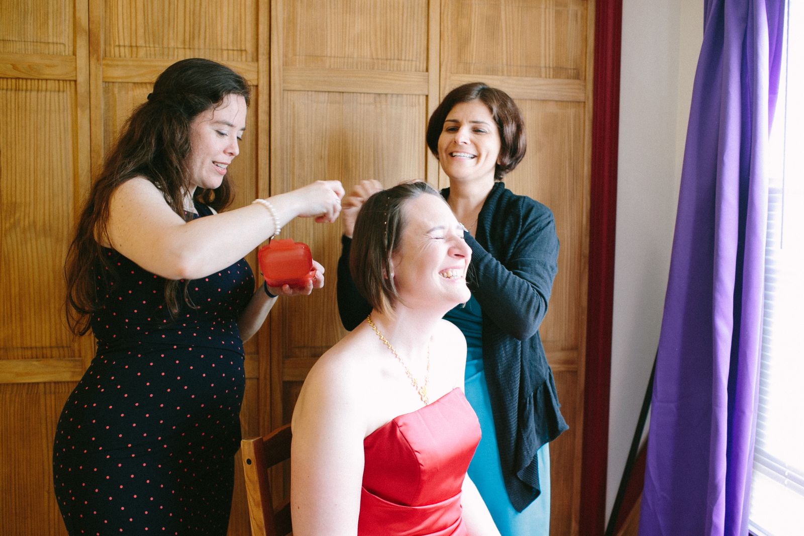 Bride laughing with friends before wedding
