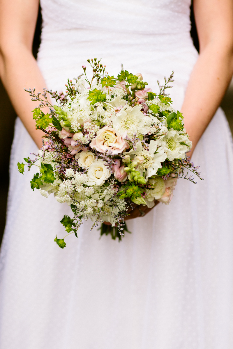 Bride holding a wildflower bouquet at a Plimoth Plantation wedding