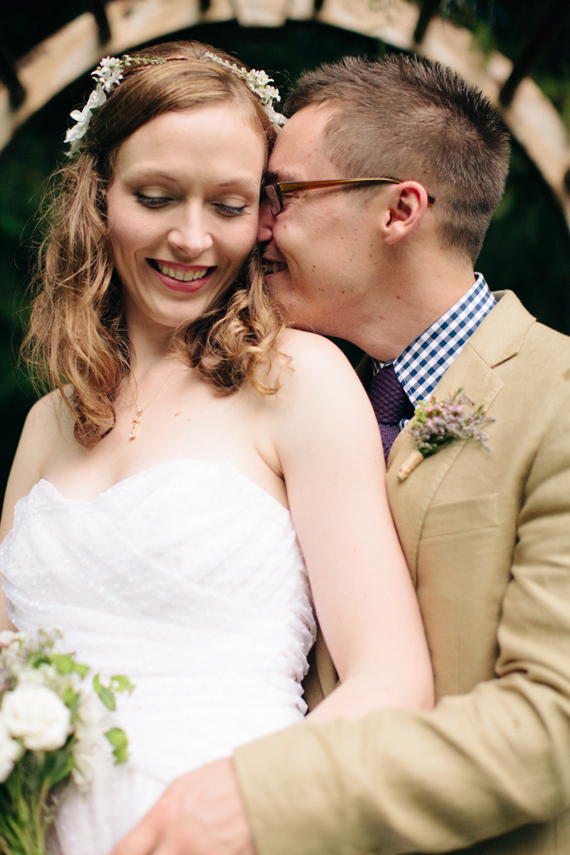 Groom whispering in his bride's ear